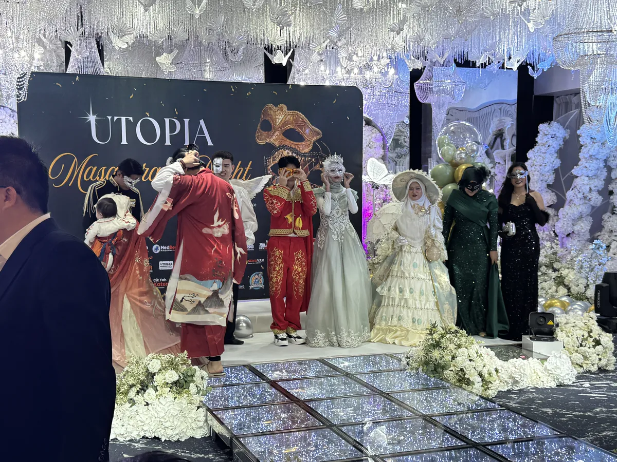 Masquerade Night — staff in elaborate costumes on stage