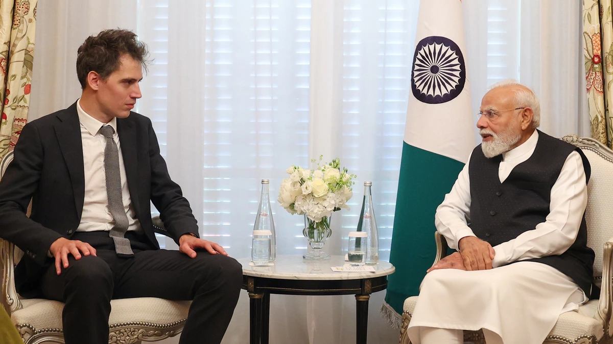 Arthur Mensch, co-founder and chief executive of Mistral AI, seated in an armchair beside India’s Prime Minister Narendra Modi, with an Indian flag between them