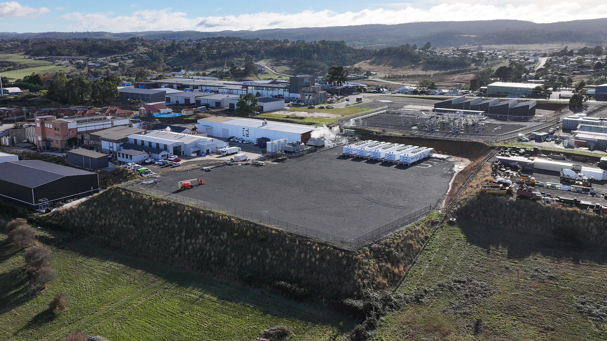 Aerial view of the Project Southgate site in northern Tasmania, showing a cleared pad beside an industrial estate and a substation