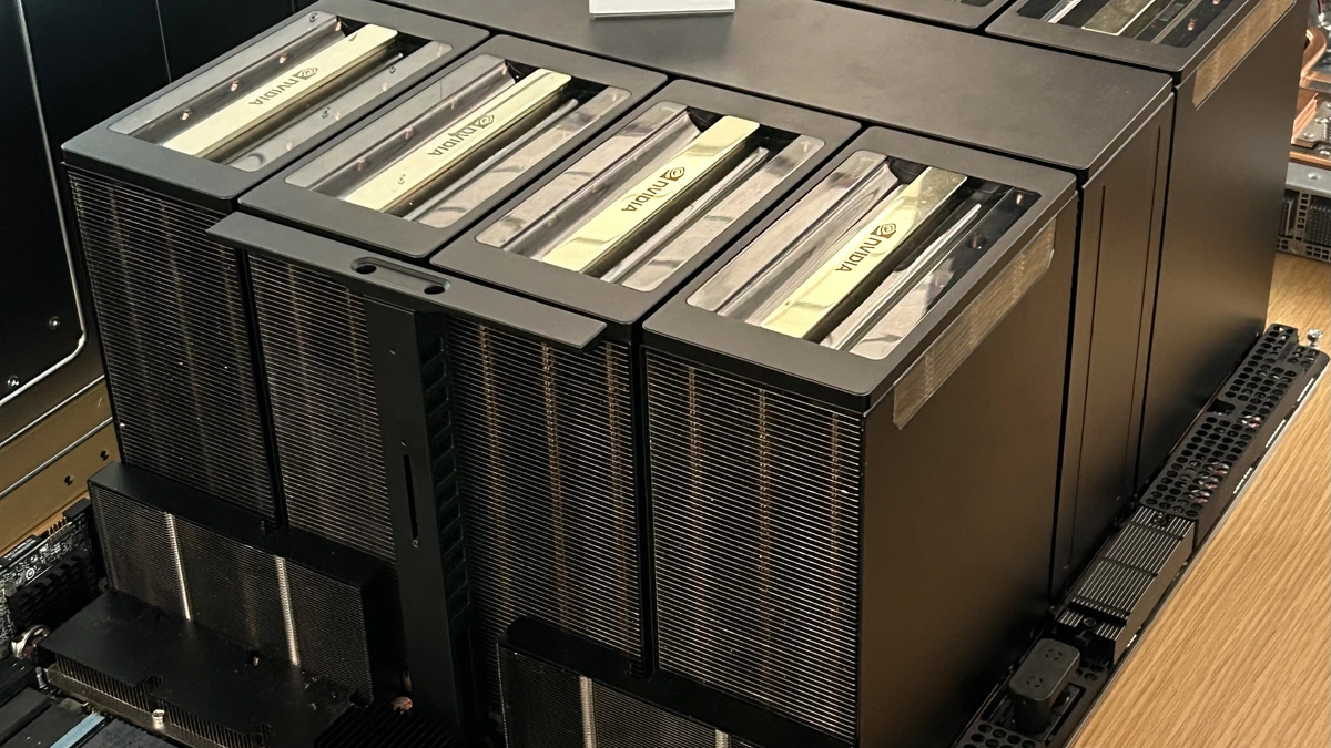 Eight black NVIDIA GPU heatsink modules on a server board labelled HGX B200 NVL8, resting on a wooden bench